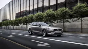 Caption: Stylish And Sophisticated - Volvo V60 On A Scenic Road Wallpaper