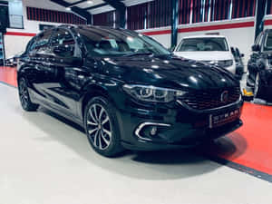 Caption: Stylish And Spacious Fiat Tipo Hatchback On The Road Wallpaper