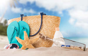 Caption: Stylish Beach Bag And Accessories On Sandy Shore Wallpaper