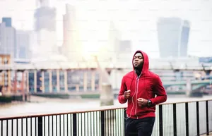 Caption: Stylish Person In A Vibrant Red Hoodie Wallpaper