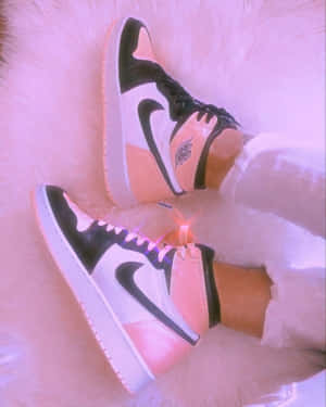 Caption: Stylish Pink Heels On A Silver Reflective Surface Wallpaper