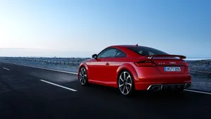 Caption: Stylish Red Audi Tt On The Road Wallpaper