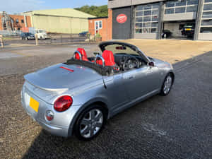 Caption: Stylish Red Daihatsu Copen On Open Road Wallpaper