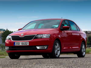 Caption: Stylish Skoda Rapid In Vibrant Setting Wallpaper