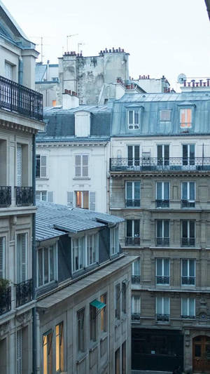 Caption: Tranquil Baby Blue Sky Over Rooftop Apartments Wallpaper