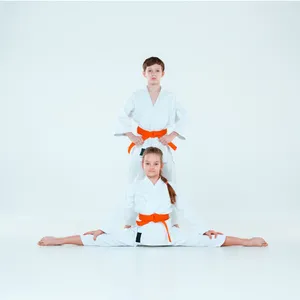 Caption: Two Martial Artists In Traditional Uniforms Demonstrating A Technique Wallpaper