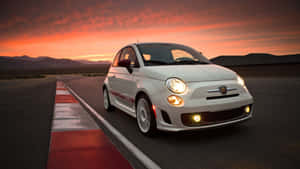 Caption: Vibrant Fiat Cinquecento Parked In A Serene Street Wallpaper