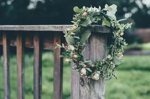Caption: Vibrant Floral Wreath With A Variety Of Blooms And Foliage Wallpaper