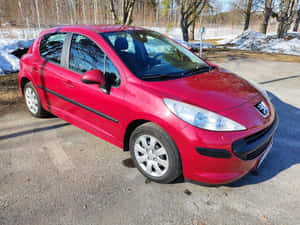 Caption: Vibrant Peugeot 207 In Urban Environment Wallpaper