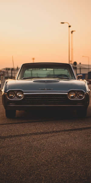 Caption: Vintage Ford Thunderbird Cruising The Streets Wallpaper