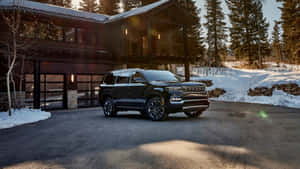 Caption: Vintage Jeep Wagoneer On Scenic Road Wallpaper