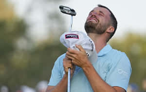 Caption: Wyndham Clark Swinging His Club Professionally Wallpaper