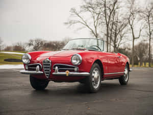 Captivating Alfa Romeo Spider In A Stunning Scenic Background Wallpaper