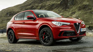 Captivating Alfa Romeo Stelvio In Picturesque Landscape Wallpaper