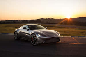 Captivating Aston Martin Vantage On A Scenic Road Wallpaper