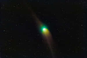 Captivating Comet In The Night Sky Wallpaper