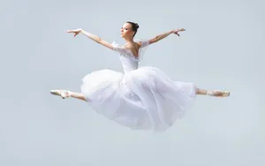 Captivating Leap Of Grace: Ballerina Mid-air Wallpaper
