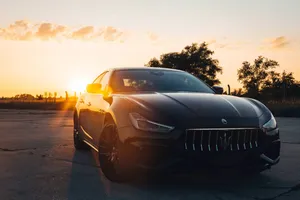 Captivating Maserati Ghibli On Open Road Wallpaper