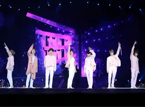 Captivating Moment Of Bts Performing On Stage Wallpaper
