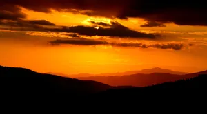 Captivating Orange Sunset Over The Horizon Wallpaper