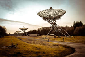 Captivating Radio Telescope In Vast Open Field Wallpaper