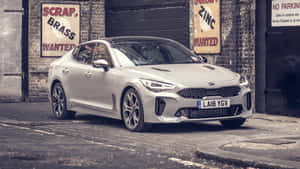 Captivating Red Kia Stinger On The Open Road Wallpaper