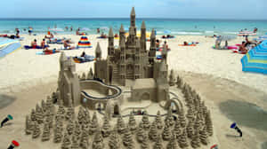 Captivating Sandcastle Masterpiece On A Beautiful Beach Wallpaper