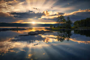 Captivating Sunset Reflection Over A Tranquil Lake Wallpaper