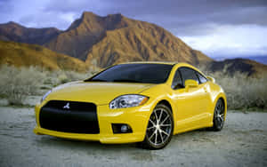 Captivating Yellow Car On A Scenic Road Wallpaper