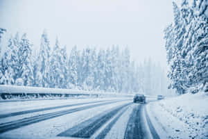 Car Driving On Snow-covered Road In Winter Wallpaper