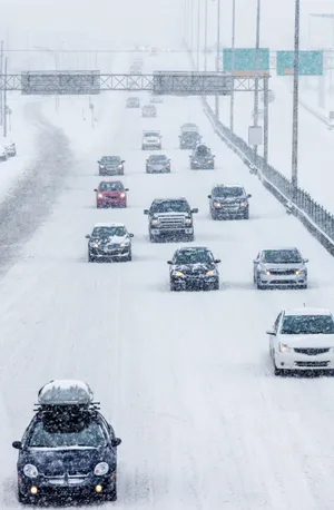Car Driving Through A Snowy Landscape During Winter Wallpaper