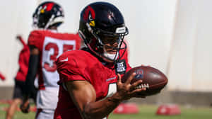 Cardinals Player Catching Football Practice Wallpaper