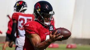 Cardinals Player Catching Football Practice Wallpaper