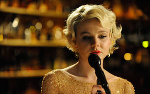 Carey Mulligan In Golden Dress Singing Wallpaper