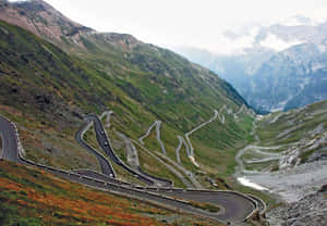 Cars Passing On The Mountain Road Wallpaper