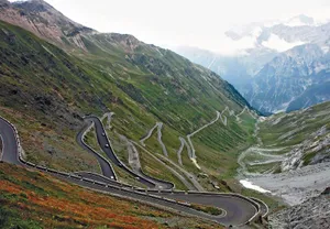 Cars Passing On The Mountain Road Wallpaper