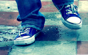 Casual Blue Sneakerson Wet Pavement Wallpaper