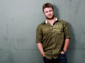 Casual Man Leaning Against Wall Wallpaper