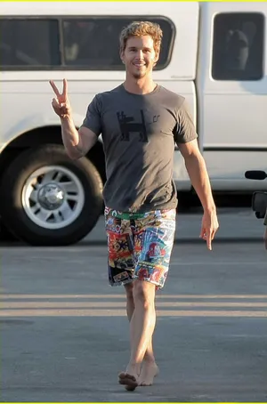 Casual Man Peace Sign Walking Barefoot Wallpaper