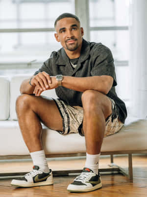 Casual Man Seated Indoors Wallpaper