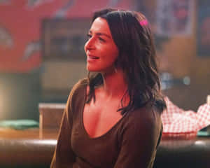 Caterina Scorsone Smilingin Bar Setting Wallpaper