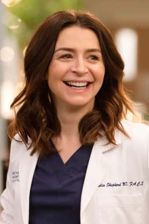 Caterina Scorsone Smilingin White Coat Wallpaper