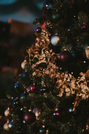 Celebrate Christmas With A Beautiful Tree Decorated With Ornaments Wallpaper