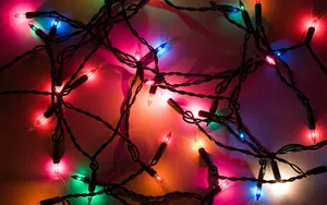 Celebrate The Holiday Season With A Beautiful Display Of Christmas Lights Wallpaper