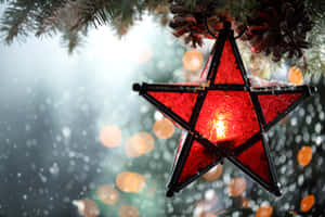 Celebrate The Spirit Of Christmas With A Sparkling Star. Wallpaper