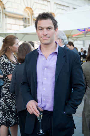 Celebrated Actor Dominic West Elegantly Posing For A Photoshoot. Wallpaper