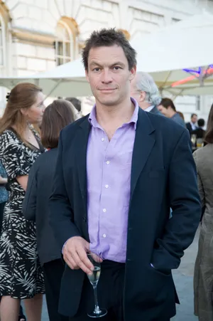 Celebrated Actor Dominic West Elegantly Posing For A Photoshoot. Wallpaper