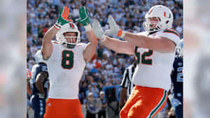 Celebratory Football Players High Five Wallpaper