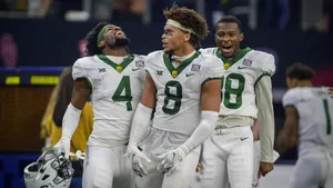 Celebratory Football Players On Field Wallpaper