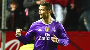 Celebratory Soccer Playerin Purple Jersey Wallpaper